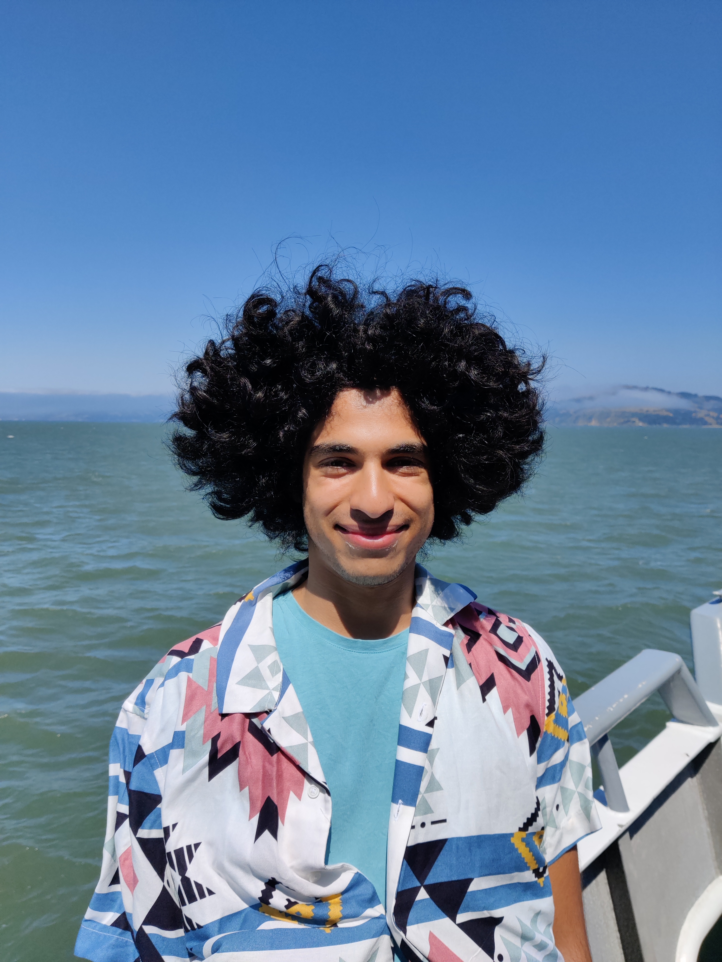 Me standing on a boat with messy hair being blown about